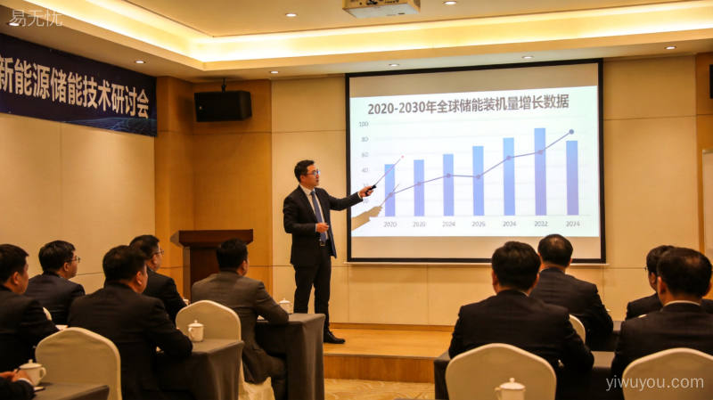 新能源储能技术研讨会上演讲者展示全球储能市场增长趋势数据,台下企业家和投资人专注聆听行业分析报告